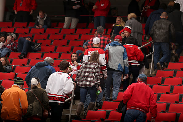 RALEIGH, NC - DECEMBER 19: Fans leave the building following an announcement that an NHL game between the Carolina Hurricanes and the Detroit Red Wings is postponed due to a mechanical failure in the system that makes the ice surface on December 19, 2016 at PNC Arena in Raleigh, North Carolina. (Photo by Gregg Forwerck/NHLI via Getty Images)