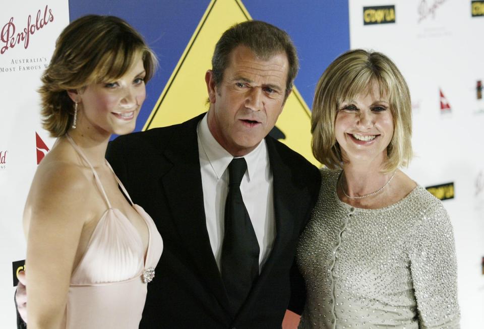 Delta Goodrem (left), Mel Gibson, and Olivia Newton-John in Los Angeles in 2005 (Francis Specker/Alamy/PA)