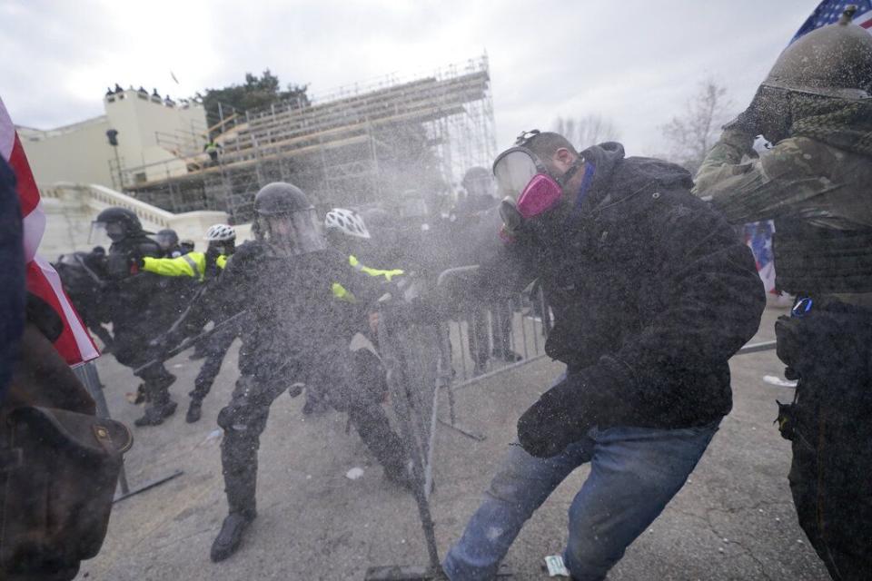 Trump supporters try to break through a police barrier, Wednesday, Jan. 6, 2021, at the Capitol in Washington. As Congress prepares to affirm President-elect Joe Biden's victory, thousands of people have gathered to show their support for President Donald Trump and his claims of election fraud. (AP Photo/Julio Cortez)