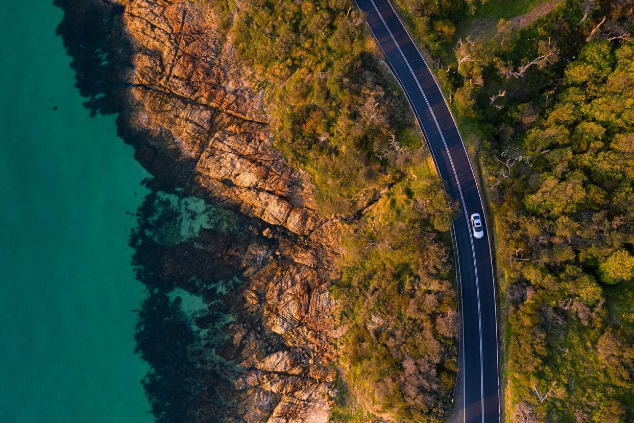 Aerial view of a car driving on the Mount Martha coastal drive located in the Mornington Peninsula.