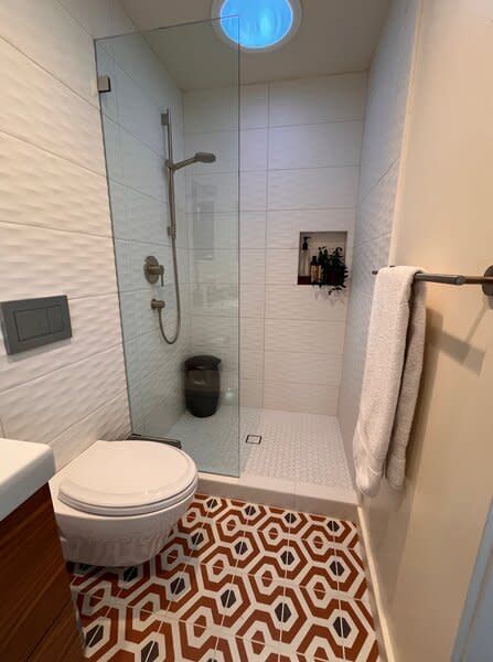 Wall and shower tile from All Natural Stone in Berkeley is paired with Artisan Tiare porcelain tile from the Tile Shop in the bathroom.