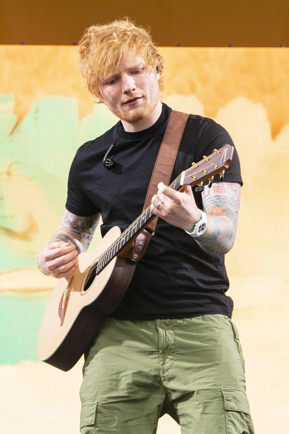 ed playing guitar on stage