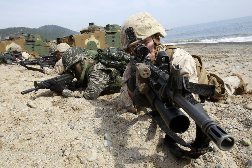 South Korean and U.S. Marines aim their machine guns during the U.S.-South Korea joint landing exercises called Ssangyong, part of the Foal Eagle military exercises, in Pohang, South Korea, Monday, March 31, 2014. South Korea said North Korea has announced plans to conduct live-fire drills near the rivals' disputed western sea boundary. The planned drills Monday come after an increase in threatening rhetoric from Pyongyang and a series of rocket and ballistic missile launches in an apparent protest against the annual military exercises by Seoul and Washington. (AP Photo/Ahn Young-joon)