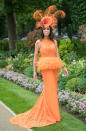 A racegoer in an orange lace dress with a matching hat. <em>[Photo: Getty]</em>