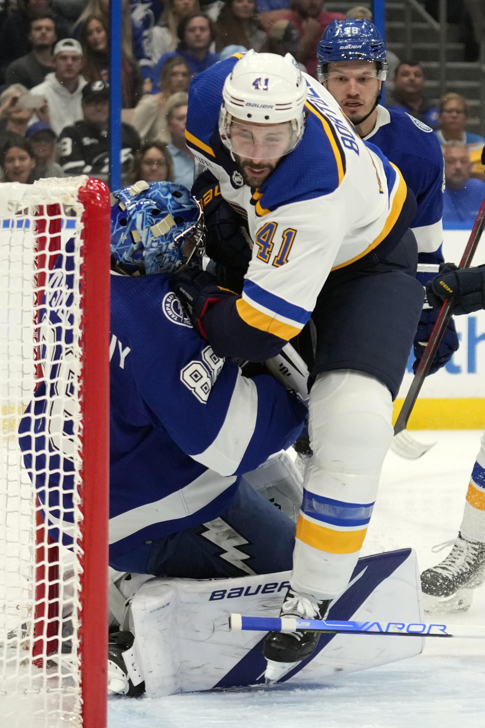 St. Louis Blues defenseman Robert Bortuzzo (41) crashes into Tampa Bay Lightning goaltender Andrei Vasilevskiy (88) during the first period of an NHL hockey game Friday, Nov. 25, 2022, in Tampa, Fla. Bortuzzo was penalized on the play. (AP Photo/Chris O'Meara)