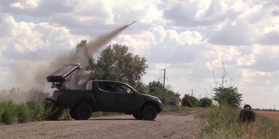 Ukrainian troops fire multiple launch rocket system from pickup truck