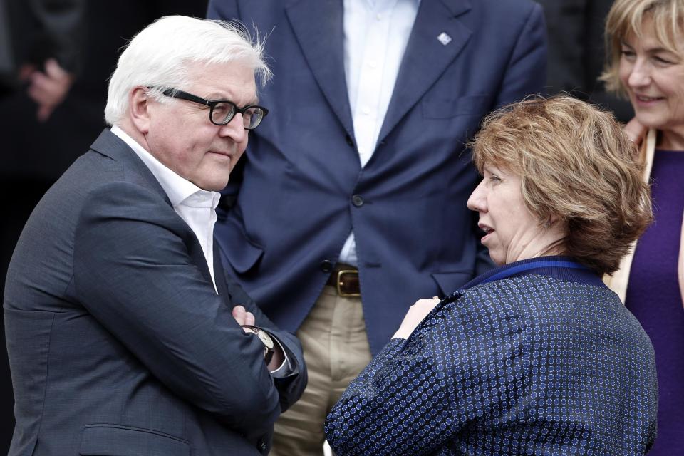 German Foreign Minister Frank-Walter Steinmeier, left, chat with Vice President of the European Commission and High Representative of the Union for Foreign Affairs and security policy Catherine Ashton, as they prepare for a photo during an Informal meeting of Ministers for Foreign Affairs at Zappeion Hall in Athens, on Friday, April 4, 2014. European Union foreign ministers meeting in Athens on Friday urged Russia to take concrete steps to pull troops back from its border with Ukraine but said they wanted to keep communication with Moscow open.(AP Photo/Petros Giannakouris)