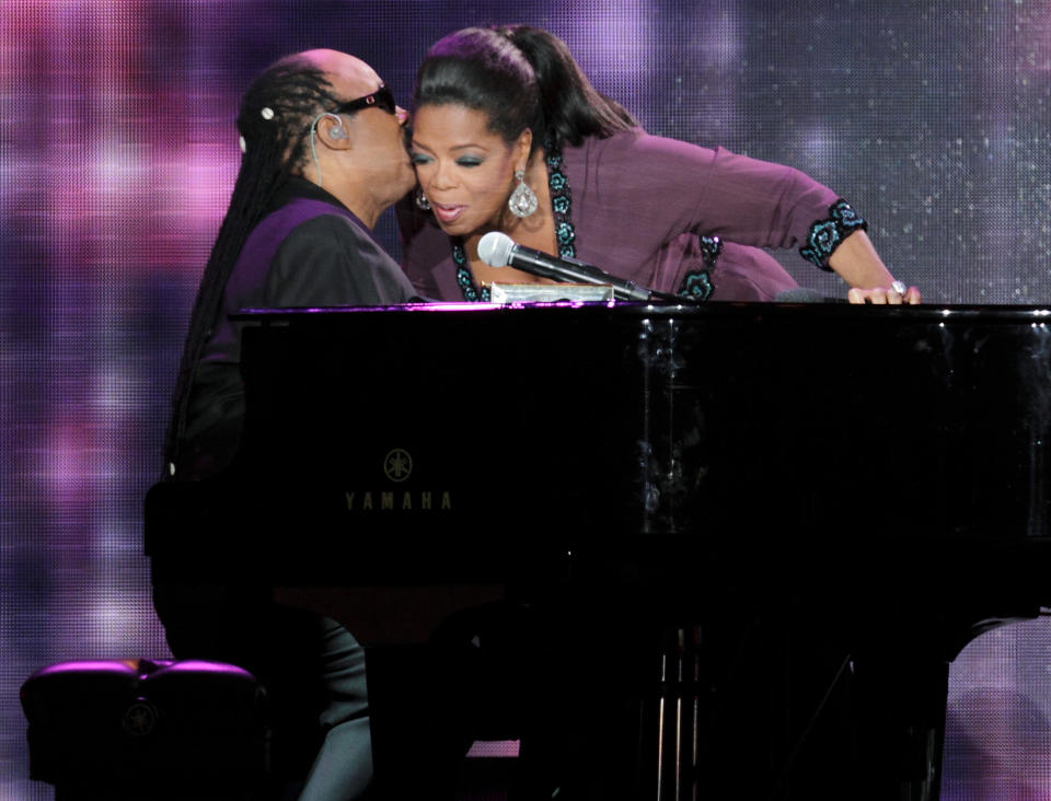 Oprah Winfrey greets singer Stevie Wonder during the taping of "Oprah's Surprise Spectacular" in Chicago May 17, 2011. Winfrey kicked off one of her last-ever national talk shows on Tuesday with hugs from Tom Hanks, Tom Cruise and Madonna in a packed Chicago arena.    REUTERS/John Gress (UNITED STATES - Tags: ENTERTAINMENT PROFILE)