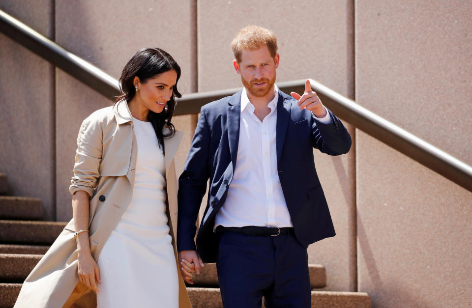 Britain's Prince Harry and wife Meghan, Duchess of Sussex walk during a visit at the Sydney Opera House in Sydney, Australia October 16, 2018. REUTERS/Phil Noble     TPX IMAGES OF THE DAY