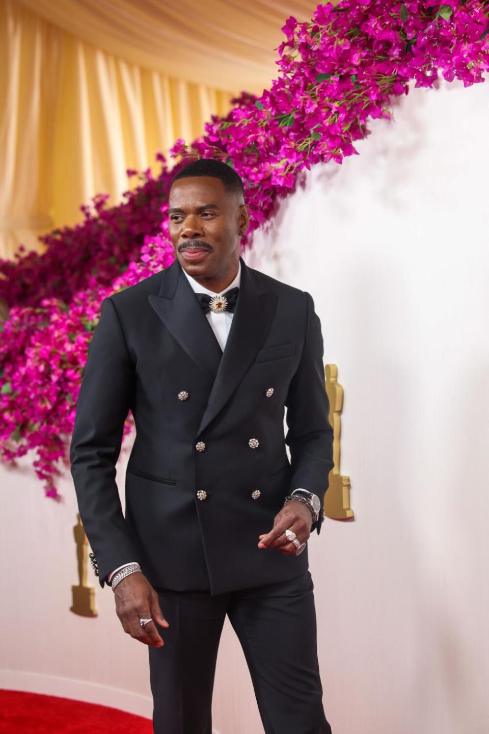 Colman Domingo wears a black suit.