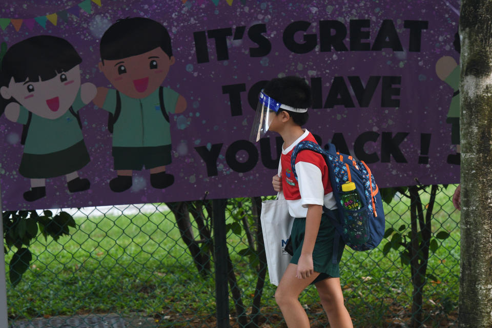 SINGAPORE, June 2, 2020  -- A primary school student wearing a face shield arrives at school in Singapore on June 2, 2020. Schools in Singapore reopened on Tuesday as the state embarked on a phased reopening from a COVID-19 