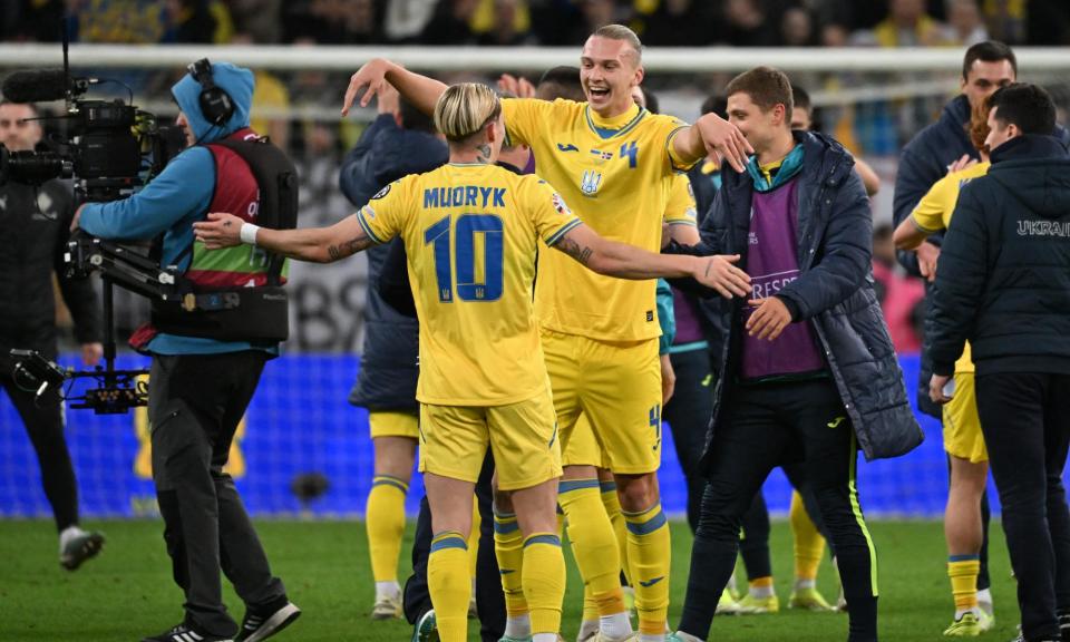 <span>Mykhaylo Mudryk and Maksym Talovierov celebrate after the match between Ukraine and Iceland in Wrocław, Poland.</span><span>Photograph: Sergei Gapon/AFP/Getty Images</span>