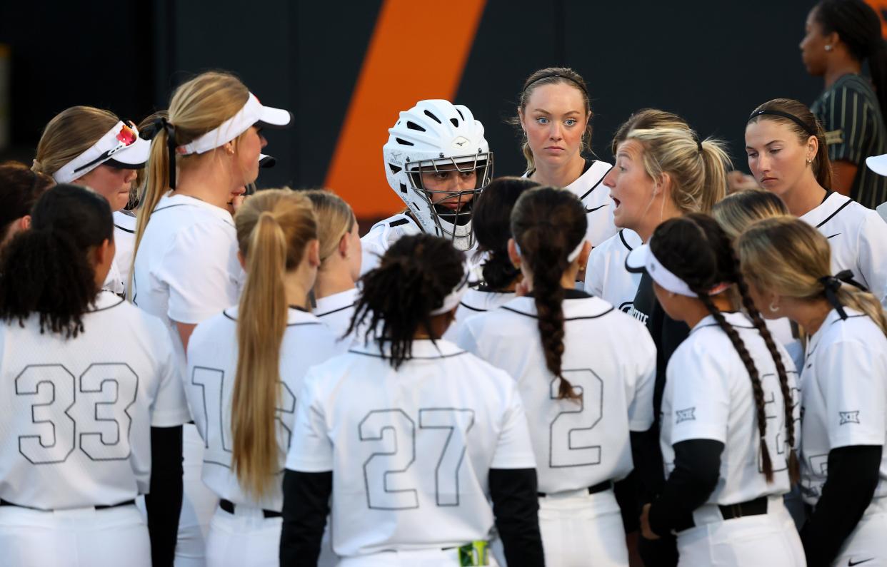 Oklahoma State huddles during the college softball game between the Oklahoma State University Cowgirls and the UCF Knights in Stillwater, Okla., Friday, March 15, 2024.