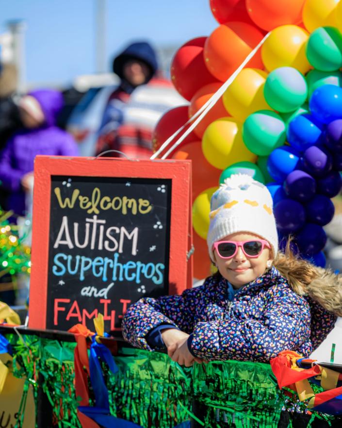 Quinn Asaff, 8, rides the Raising Harts float.