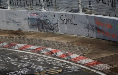 FILE PHOTO: A graffiti is seen at a damaged circuit boundary at the "Breitscheid" section of the Nuerburgring Nordschleife racing circuit