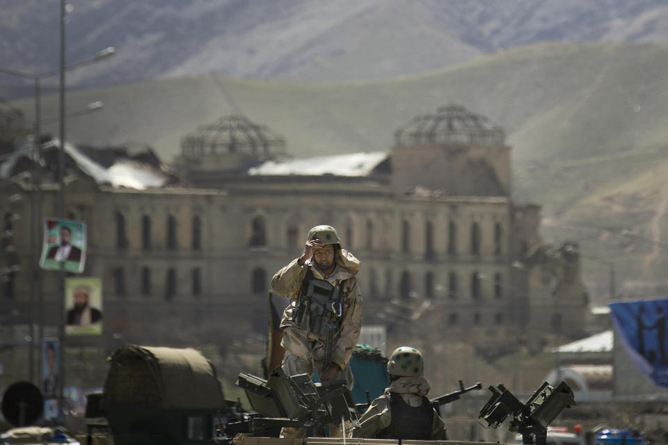 Afghan special forces arrive to the scene after the Taliban launched an assault with a suicide bomber detonating his vehicle outside an election office on the edge of Kabul, Afghanistan, Tuesday, March 25, 2014. Gunmen stormed into the building, trapping dozens of employees inside and killing many people. A candidate for a seat on a provincial council was among those killed, along with an election worker, a civilian and a policeman. (AP Photo/Anja Niedringhaus)