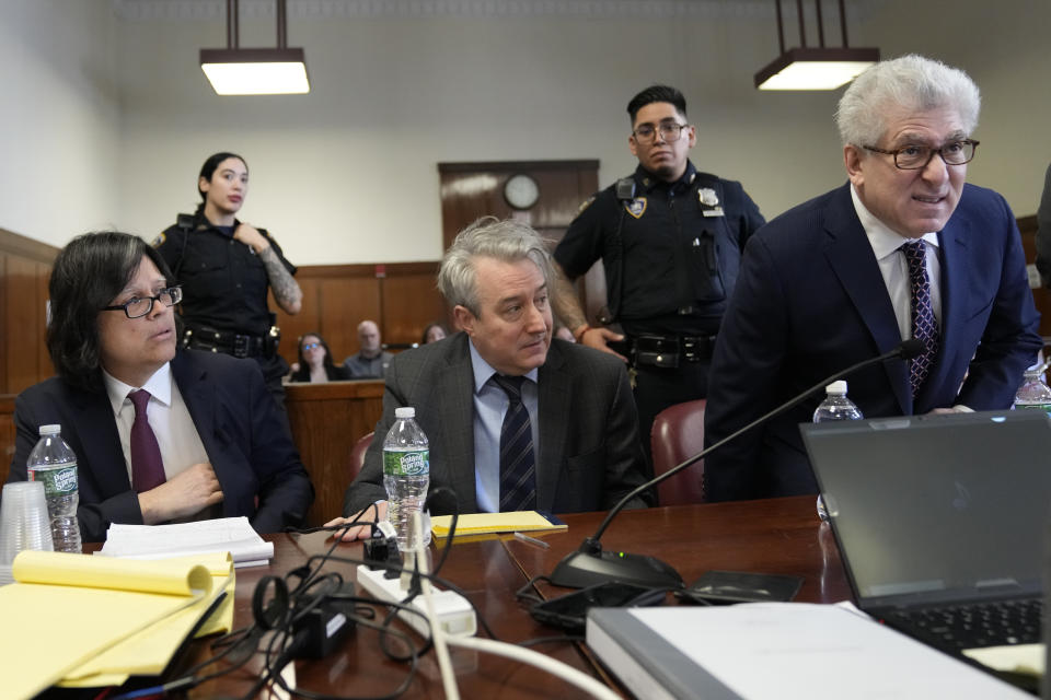 Defendants memorabilia seller Edward Kosinski, left, former Rock & Roll Hall of Fame curator Craig Inciardi, center, and rare-book dealer Glenn Horowitz take a seat at the defense table in Supreme Court, Thursday, Feb. 22, 2024, in New York. A judge in New York will continue hearing testimony today in a criminal case involving ownership of the handwritten lyrics for the songs on the "Hotel California" album by The Eagles. (AP Photo/Mary Altaffer)