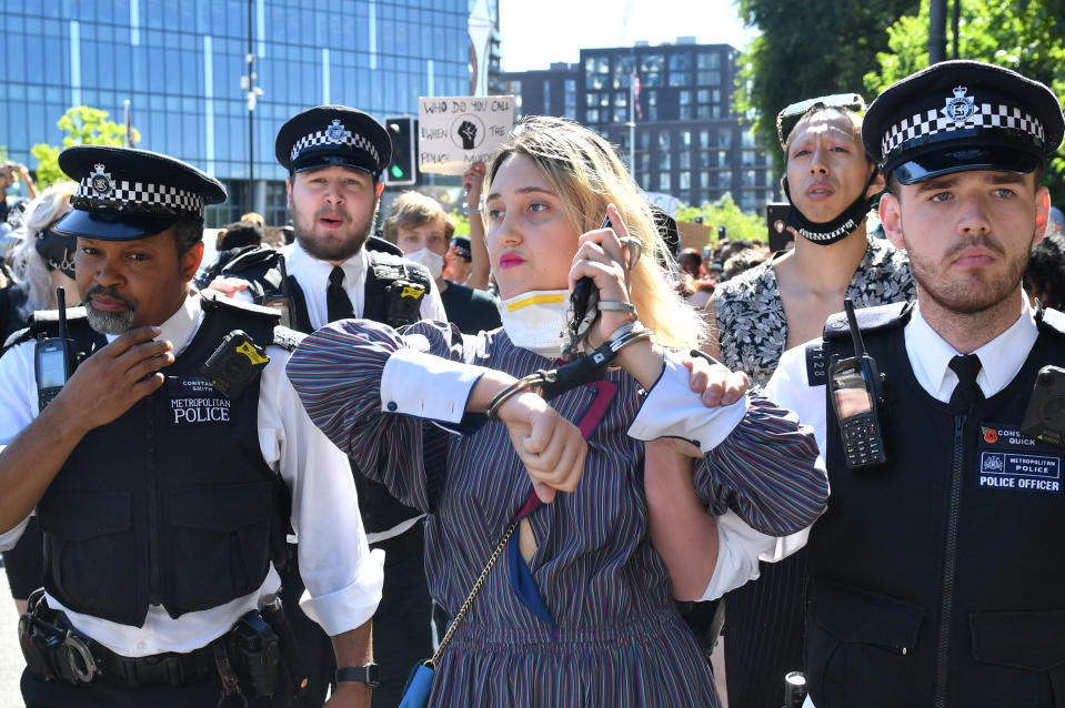 A woman is led away by police during a Black Lives Matter protest outside the US Embassy in London. The protest follows the death of George Floyd in Minneapolis, US, this week which has seen a police officer charged with third-degree murder. (Photo by Dominic Lipinski/PA Images via Getty Images)