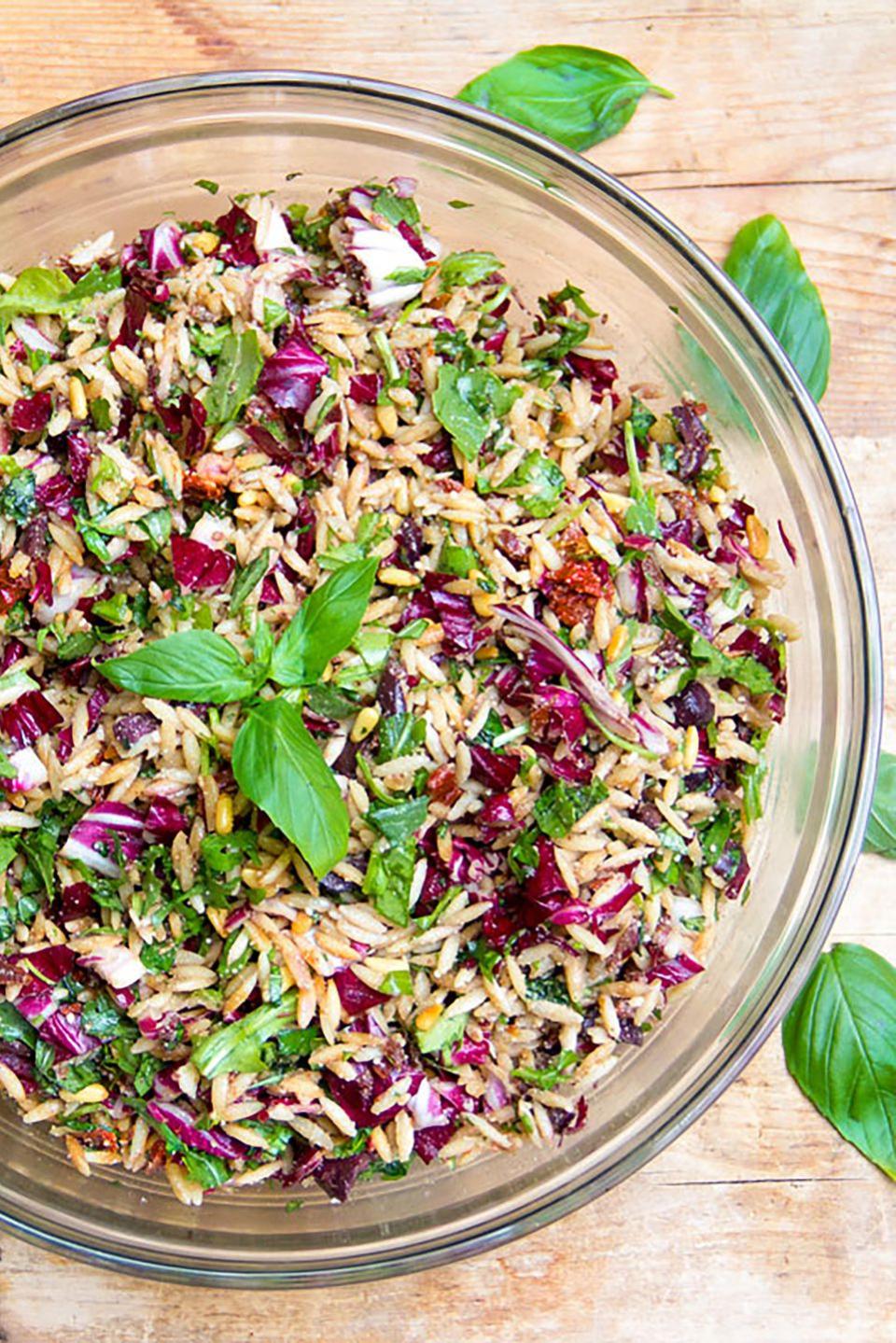 <p>What does the "out of this world" pasta salad include? Sun-dried tomatoes, kalamata olives, greens, parmigiana cheese, orzo, and toasted pine nuts. Simply toss it with oil and vinegar, and serve.</p><p><strong>Get the recipe at <a rel="nofollow noopener" href="http://www.panningtheglobe.com/2013/07/22/out-of-this-world-pasta-salad-recipe/" target="_blank" data-ylk="slk:Panning the Globe;elm:context_link;itc:0;sec:content-canvas" class="link ">Panning the Globe</a>. </strong></p>