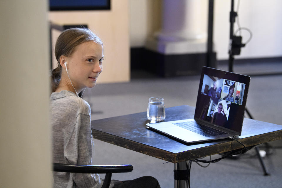 Environmental activist Greta Thunberg talks via video link with Professor of Environmental Science Johan Rockstrom in Germany, during a live chat on International Earth Day where they discussed the coronavirus pandemic and the environment, at the Nobel Museum in Stockholm, Sweden, Wednesday, April 22, 2020. (Jessica Gow/TT News Agency via AP)