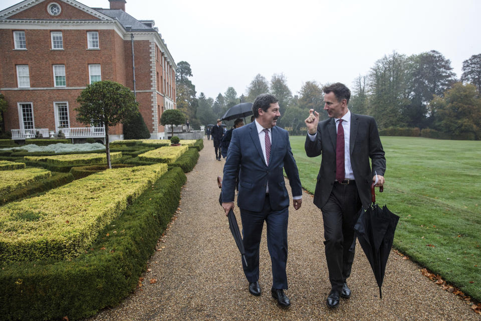 Britain's Foreign Secretary Jeremy Hunt walks with Slovakian Europe Minister Frantisek Ruzickas, left, during a walk in the grounds of Chevening House, in Sevenoaks, England, Sunday, Oct. 14, 2018. Hunt played host to Eastern European Foreign Ministers at his official country residence ahead of a meeting on Monday at the Foreign Affairs Council in Luxembourg where chemical weapons sanctions will be formally adopted. (Jack Taylor/Pool Photo via AP)