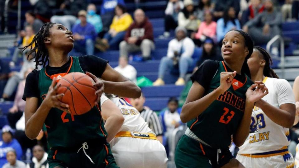 Frederick Douglas’ Ayanna-Sarai Darrington, left, and Jaelee Knowles (23) crashed the boards in their game at Henry Clay on Friday. Darrington led the Broncos with 20 points and 17 rebounds.
