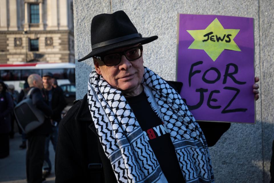 <em>A pro-Jeremy Corbyn protester holds a placard during a counter-protest to a demonstration in Parliament Square against anti-Semitism in the Labour Party (Getty)</em>