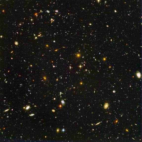 This view of nearly 10,000 galaxies is called the Hubble Ultra Deep Field. The snapshot includes galaxies of various ages, sizes, shapes, and colors. The smallest, reddest galaxies, about 100, may be among the most distant known, existing when