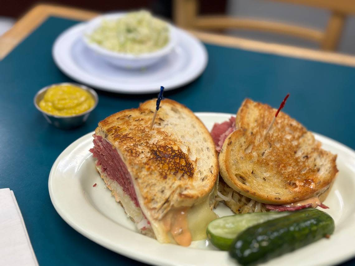 A Reuben sandwich piled with a side of cole slaw and sliced pickle, of course, at Lots of Lox in Palmetto Bay, South Miami-Dade, on April 24, 2024. Howard Cohen/hcohen@miamiherald.com