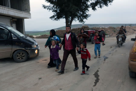 A kurdish girl reacts as she walks with her family in Afrin, Syria March 18, 2018. REUTERS/Khalil Ashawi