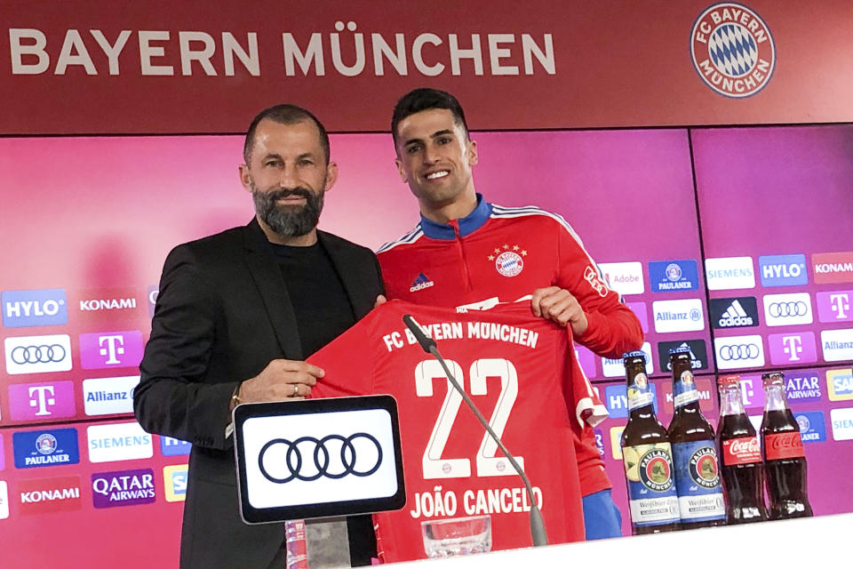 Hasan Salihamidzic, left, Sports Director of FC Bayern Munich, presents new signing Joao Cancelo at a press conference in Munich, Germany, Tuesday, Jan. 31, 2023. (Christian Kunz/dpa via AP)