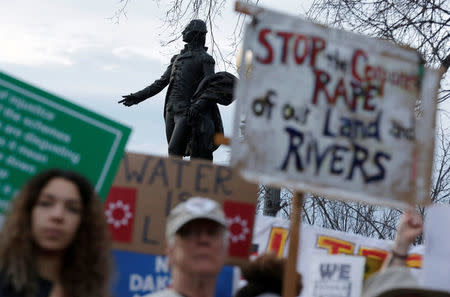 People protest under the statue of Lafayette against U.S. President Donald Trump's directive to permit the Dakota Access Pipeline during a demonstration at the White House in Washington, U.S., February 8, 2017. REUTERS/Joshua Roberts