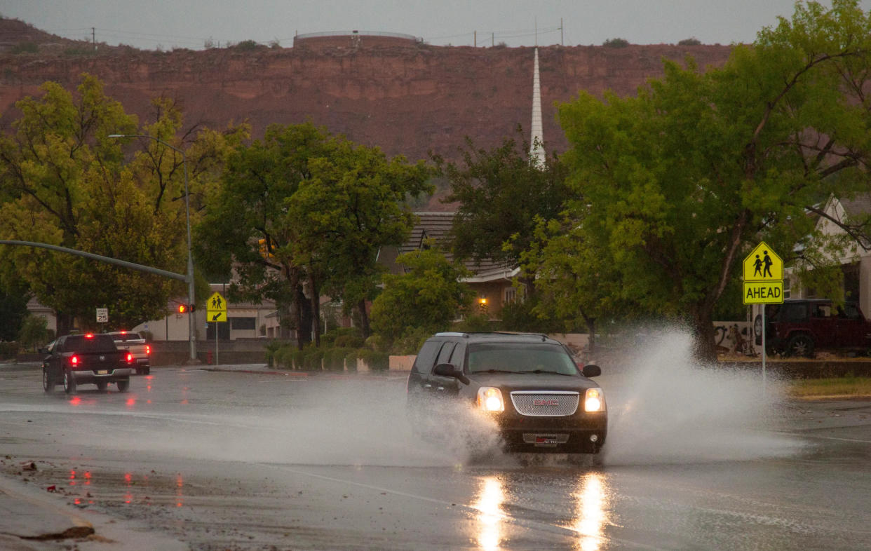 Drivers splash their way down 400 East in St. George as another rainy storm hits southern Utah. Forecasters said the storm that moved in late Sunday could last through Wednesday, adding to what has been one of the wettest seasons to hit the area in decades.