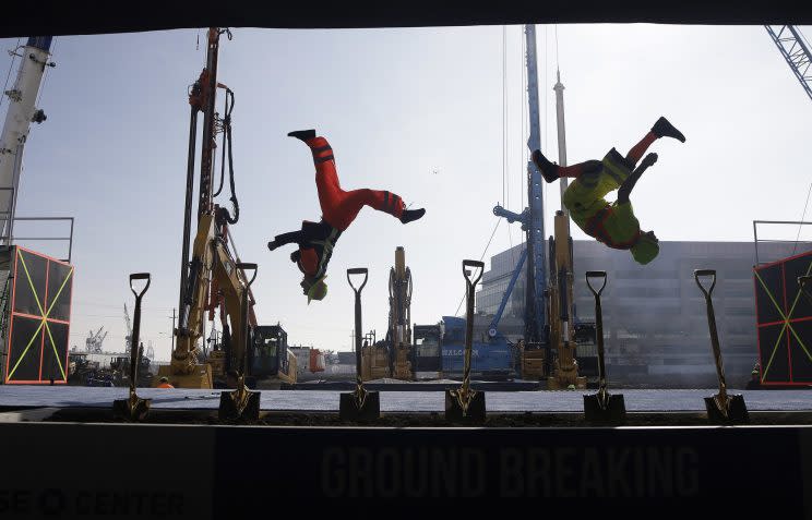 Acrobats and construction equipment perform at the Chase Center groundbreaking ceremony. (AP)