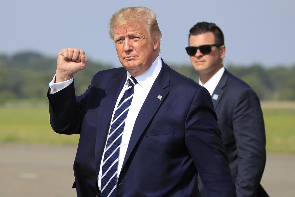 President Donald Trump waves as he walks from Air Force One upon arrival at Morristown Municipal Airport, in Morristown, N.J., Friday, July 19, 2019. (AP Photo/Manuel Balce Ceneta)