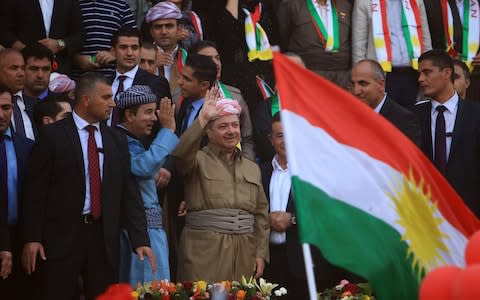 Iraqi Kurdish President Masoud Barzani salutes the crowd while attending a rally to show their support for the September independence referendum in Duhuk - Credit: Reuters