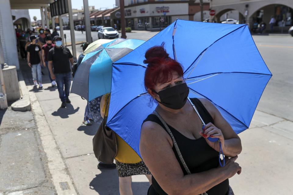 Amelia Gurrero stands in line for more than an hour to use a Bank of America ATM in Calexico.