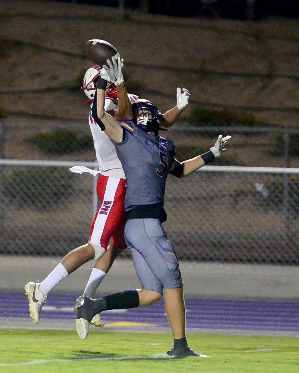 Escalon receiver Sam Jimenez (5) deflects a pass  during a game between Escalon High School and Ripon High School in Escalon, California on October 20, 2023. 