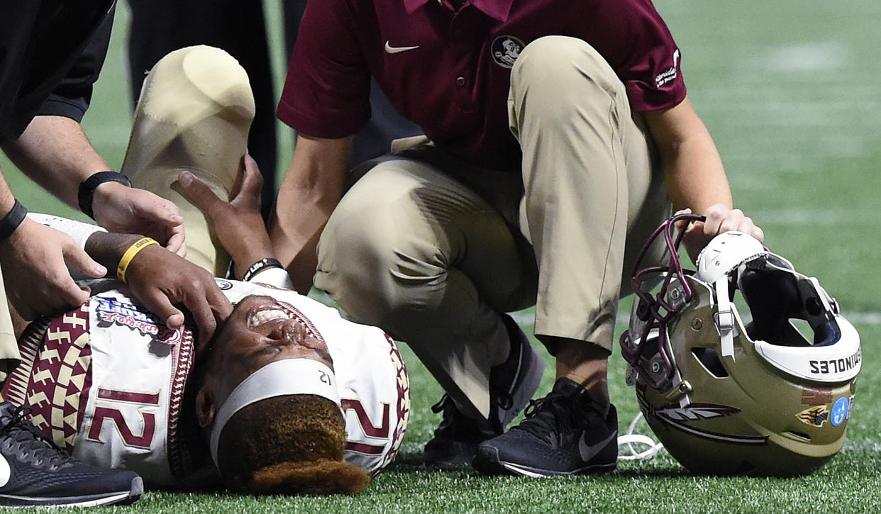 Deondre Francois reacts to his injury against Alabama defensive back Ronnie Harrison during the second half of an NCAA football game, Saturday, Sept. 2, 2017, in Atlanta. Alabama won 24-7. (AP Photo/Mike Stewart)