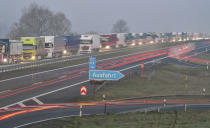 Trucks are jammed in the early morning on Autobahn 12 in front of the German-Polish border crossing near Frankfurt (Oder), Germany, Wednesday, March 18, 2020. In order to make it more difficult for the corona virus to spread, Poland had reintroduced controls at the border crossings to Germany. For most people, the new coronavirus causes only mild or moderate symptoms, such as fever and cough. For some, especially older adults and people with existing health problems, it can cause more severe illness, including pneumonia. (Patrick Pleul/dpa via AP)