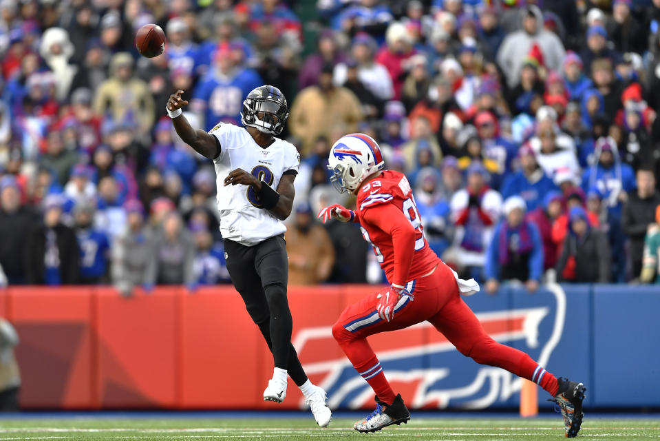 Baltimore Ravens quarterback Lamar Jackson (8) throws a pass under pressure by Buffalo Bills defensive end Trent Murphy (93) during the second half of an NFL football game in Orchard Park, N.Y., Sunday, Dec. 8, 2019. The Ravens won 24-17. (AP Photo/Adrian Kraus)