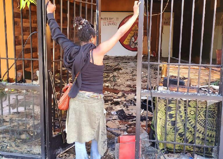 Zahalea Anderson looks at the burned-out remains of her business in Long Beach. (Courtesy of Zahalea Anderson)