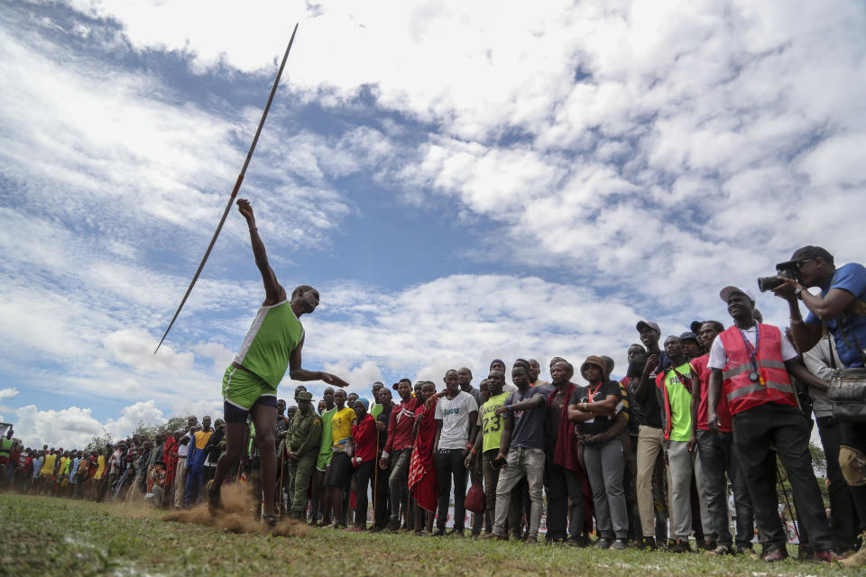 A Maasai man throws a javelin as he competes in the Maasai Olympics in Kimana Sanctuary, southern Kenya Saturday, Dec. 10, 2022. The sports event, first held in 2012, consists of six track-and-field events based on traditional warrior skills and was created as an alternative to lion-killing as a rite of passage. (AP Photo/Brian Inganga)