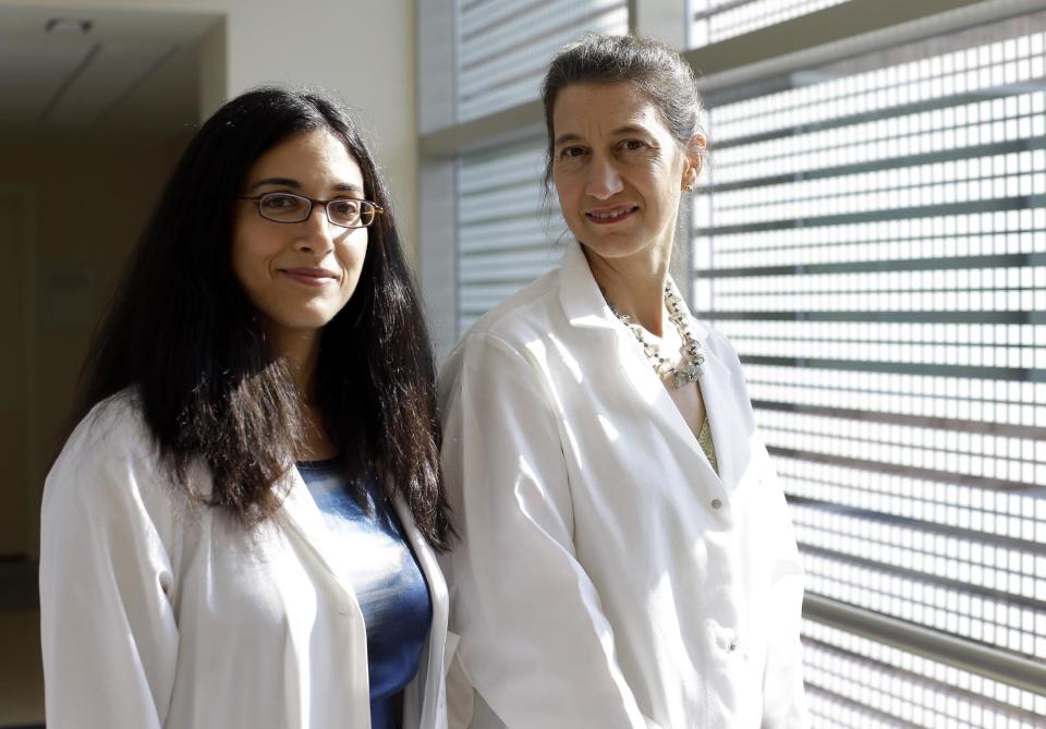 In this photo taken Aug. 21, 2012, Dr. Tara Palmore, deputy hospital epidemiologist at the National Institutes of Health Clinical Center, left, and Dr. Julie Segre, a geneticist with the National Human Genome Research Institute, pose at the NIH Clinical Center in Bethesda, Md. Last year a deadly superbug spread through the nation's leading research hospital, killing six patients before it could be stopped. Scientists at the National Institutes of Health hospital in Bethesda, Md., scrubbed with bleach, locked down patients and even ripped out plumbing. In the end, it took gene detectives analyzing the germ's DNA to trace it to its source. It came from a New York City patient who was admitted for a medical study. (AP Photo/Patrick Semansky)