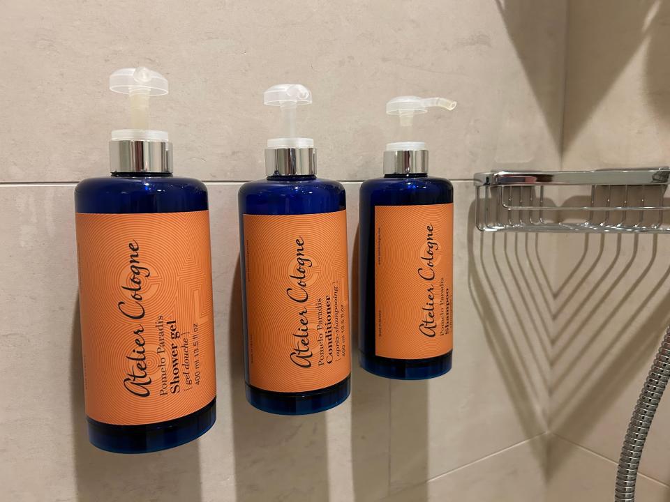 Mounted shampoo, conditioner, and soap in Disney World Four Seasons bathroom 
