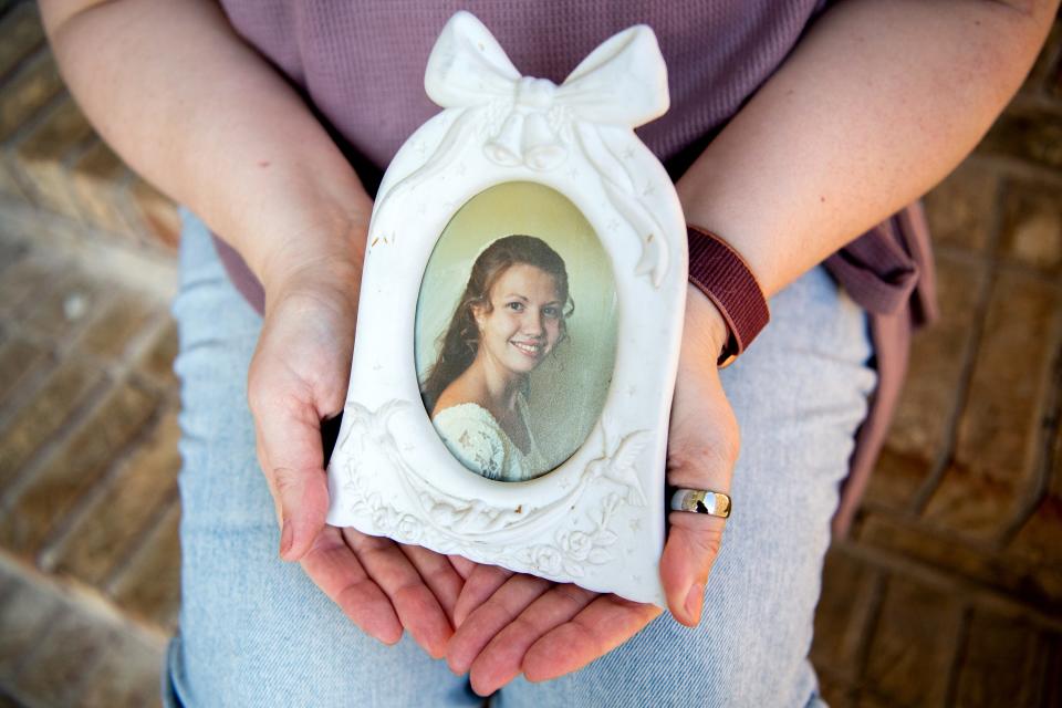 Denise Duran holds a bridal photo of her 19-year-old self from 1997 at her home in Maryville.