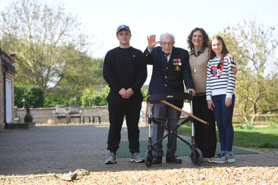 99-year-old war veteran Captain Tom Moore, with (left to right) grandson Benji, daughter Hannah Ingram-Moore and granddaughter Georgia, at his home in Marston Moretaine, Bedfordshire, after he achieved his goal of 100 laps of his garden - raising more than 12 million pounds for the NHS.