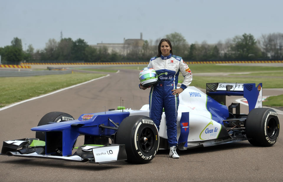 Simona De Silvestro, of Switzerland, poses next to a Sauber F1 2012 prior to a training session at Ferrari's Fiorano test track, near Modena, Italy, Saturday, April 26, 2014. Simona de Silvestro is an affiliated driver with Sauber this year with a goal of competing for a Formula One seat in 2015. The Swiss driver has spent the last four years racing in IndyCar, and scored her first career podium in October with a second-place finish at Houston. It was the first podium finish for a woman on a road course in IndyCar. The 25-year-old De Silvestro has been spending this year testing, participating in simulator training and preparing for the mental and physical demands of F1. Sauber says the goal is to help De Silvestro earn her F1 super license and prepare for a seat in 2015. (AP Photo/Marco Vasini)