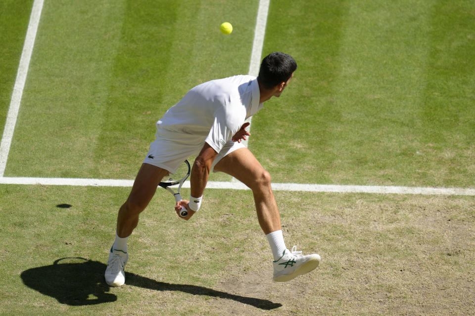 Serbia's Novak Djokovic returns to Britain's Cameron Norrie in a men's singles semifinal on day twelve of the Wimbledon tennis championships in London, Friday, July 8, 2022. (AP Photo/Kirsty Wigglesworth)