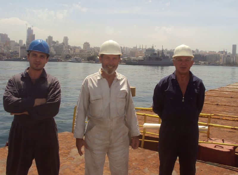 Boris Prokoshev, captain of cargo vessel Rhosus , boatswain Boris Musinchak and a crew member pose in the port of Beirut
